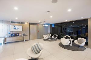 a salon with white chairs and a waiting room at Xen Hotel Nakhon Pathom - SHA PLUS in Nakhon Pathom