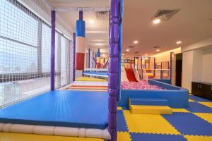 a brightly colored indoor trampoline room with colorful floors at Hotel Modern Puli in Puli +56 photos