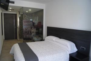 Postel nebo postele na pokoji v ubytování Hostal Sanmar