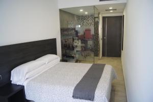 Postel nebo postele na pokoji v ubytování Hostal Sanmar