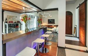 a kitchen with a bar with stools in a room at Casa Mamita in Los Llanos de Aridane