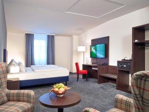 a hotel room with a bed and a desk at B&K Hotels in Vlotho