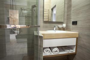 a bathroom with a sink and a mirror at Duke Apartments in Odesa +289 photos