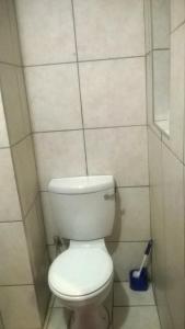 a bathroom with a white toilet in a room at Baobab Tree Guest House in Huntley