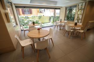 a restaurant with tables and chairs and windows at Sky Suites in Beirut