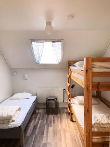 a bedroom with two bunk beds and a window at Trosa Vandrarhem in Trosa