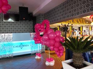 a bunch of pink balloons sitting in a store at DW California in Rewal