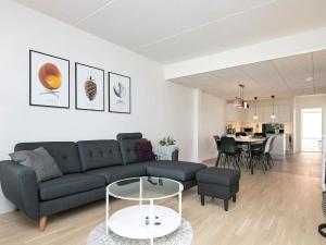 een woonkamer met een bank en een tafel bij 8 person holiday home in Ringk bing in Ringkøbing