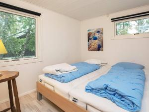 Postel nebo postele na pokoji v ubytování Holiday home Dannemare XII