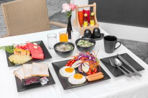 a table with three plates of food on it at Xen Hotel Nakhon Pathom - SHA PLUS in Nakhon Pathom