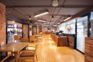 a dining room with tables and chairs in a restaurant at Xen Hotel Nakhon Pathom - SHA PLUS in Nakhon Pathom