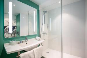 a bathroom with a sink and a shower at ibis budget Besançon Centre Gare in Besançon