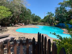 a swimming pool in a yard with a wooden fence at House 37 Nkululeko in Sodwana Bay Lodge - no loadshedding in Sodwana Bay