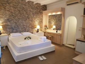 a hotel room with a bed and a bathroom at Abelonas Village in Megalochori