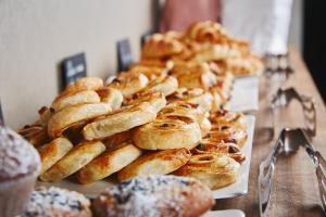 a bunch of pastries sitting on a table at Prestige Hotel Budapest in Budapest