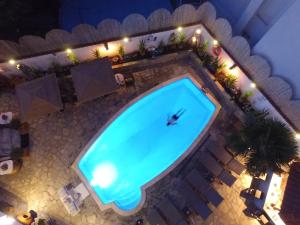 an overhead view of a swimming pool at night at Hotel Pavlidis in Limenas