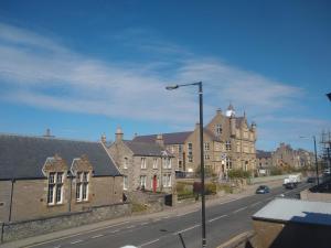 a city street with houses and a street light at Solheim Guest House in Lerwick