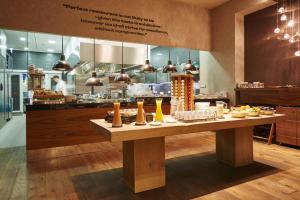 a table with food on it in front of a kitchen at Prestige Hotel Budapest in Budapest