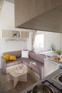 a living room with a couch and a table at Càmping Bellsol in Pineda de Mar