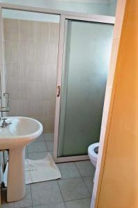 a bathroom with a shower and a sink and a toilet at Bomen Hotel in Isiolo