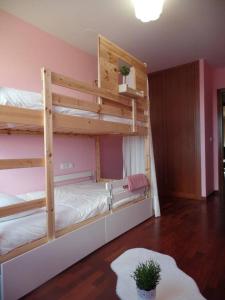 1 dormitorio con 2 literas y alfombra en PISO ACOGEDOR EN SADA COZY FLAT IN SADA WiFi, en Sada