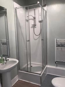 a bathroom with a shower and a sink at City Centre En-Suite Room in Edinburgh
