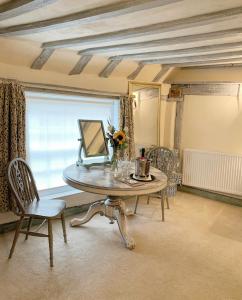 a dining room with a table with a laptop on it at The Tea House in Rye