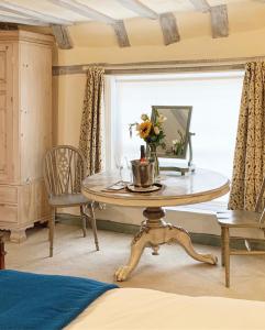 a room with a table with a vase of flowers on it at The Tea House in Rye