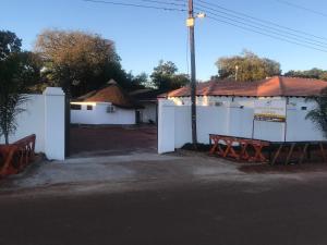 a white building with a bench in front of it at Venice royal lodge in Thohoyandou
