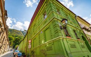 a green building on the side of a street at Lamp House in Braşov