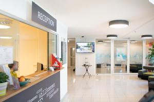 a reception area of a store with a reception counter at myNext - Riverside Hotel Salzburg in Salzburg