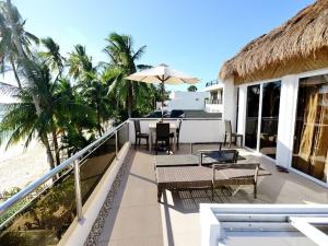 a balcony of a resort with a table and chairs at Kaiyana Boracay Beach Resort in Boracay