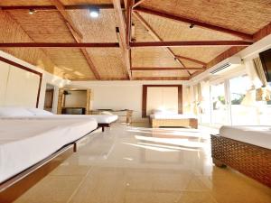 a large room with two beds and a couch at Kaiyana Boracay Beach Resort in Boracay