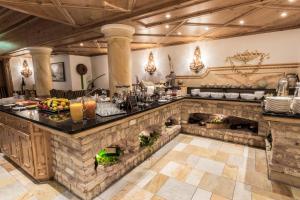 a large kitchen with a large stone counter top at Hotel Alte Post in Sankt Anton am Arlberg