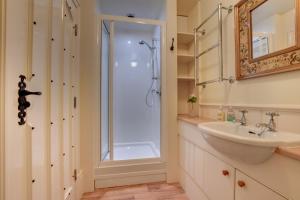 a bathroom with a shower and a sink at Middlehead Cottages in Pickering +99 photos