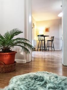 a living room with a plant and a table at Home garden oasis in Timişoara