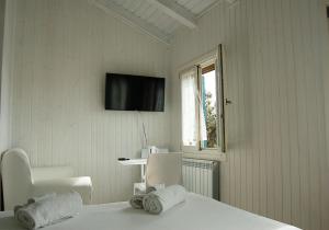 a bedroom with a bed and a tv on the wall at Junior Suites Venezia in Venice