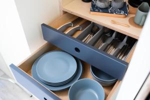 a drawer with plates and utensils in a kitchen at Black Knowe, Luxury Glamping Pods, Ballycastle in Ballycastle