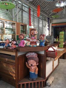 a group of figurines sitting at a counter in a store at Aunt & Uncle's House in Chiang Mai