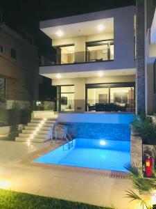 a house with a swimming pool in front of it at Ixia Breeze 1 in Ixia