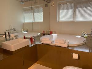 a large bathroom with a tub and a sink at B&B Yellow Submarine in Antwerp +25 photos
