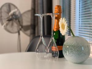 two wine glasses and a bottle on a table at B&B Yellow Submarine in Antwerp