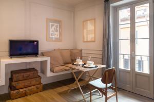 a living room with a couch and a table at Suites Menaggio in Menaggio