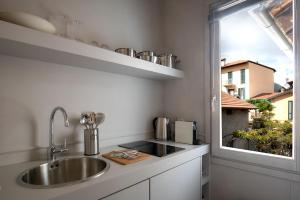 a kitchen counter with a sink and a window at Suites Menaggio in Menaggio