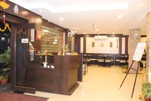 a restaurant with a bar and a dining room at Hotel Venkateshwar in Aurangabad