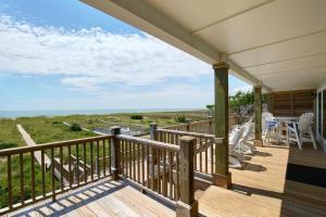 a porch with a view of the ocean at Dune Deck North - Duplex in Holden Beach
