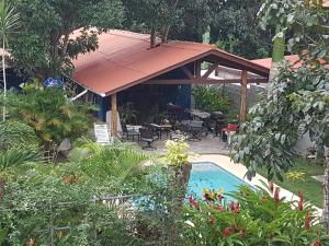 a garden with a swimming pool and a pavilion at The Blue House Panama in Chame