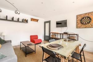 a living room with a table and a couch at Appartement Croisé Laroche 40m2 in Marcq-en-Baroeul