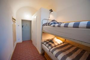 two bunk beds in a room with a hallway at Stadthotel - Das alte Gefängnis in Braunau am Inn