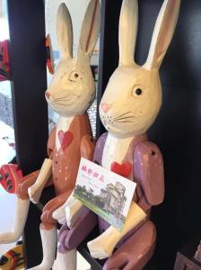 two stuffed rabbits sitting next to each other at Green Field Sweet House in Jiaoxi